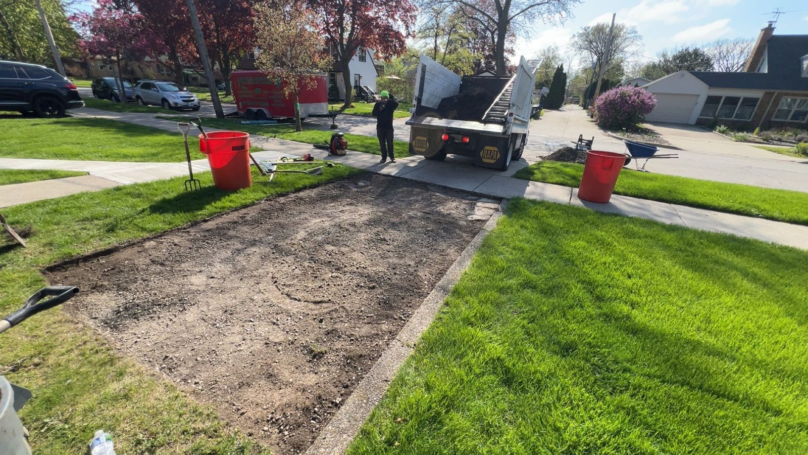 Front yard mid-install — old turf removed, new sod being laid, MarioScape