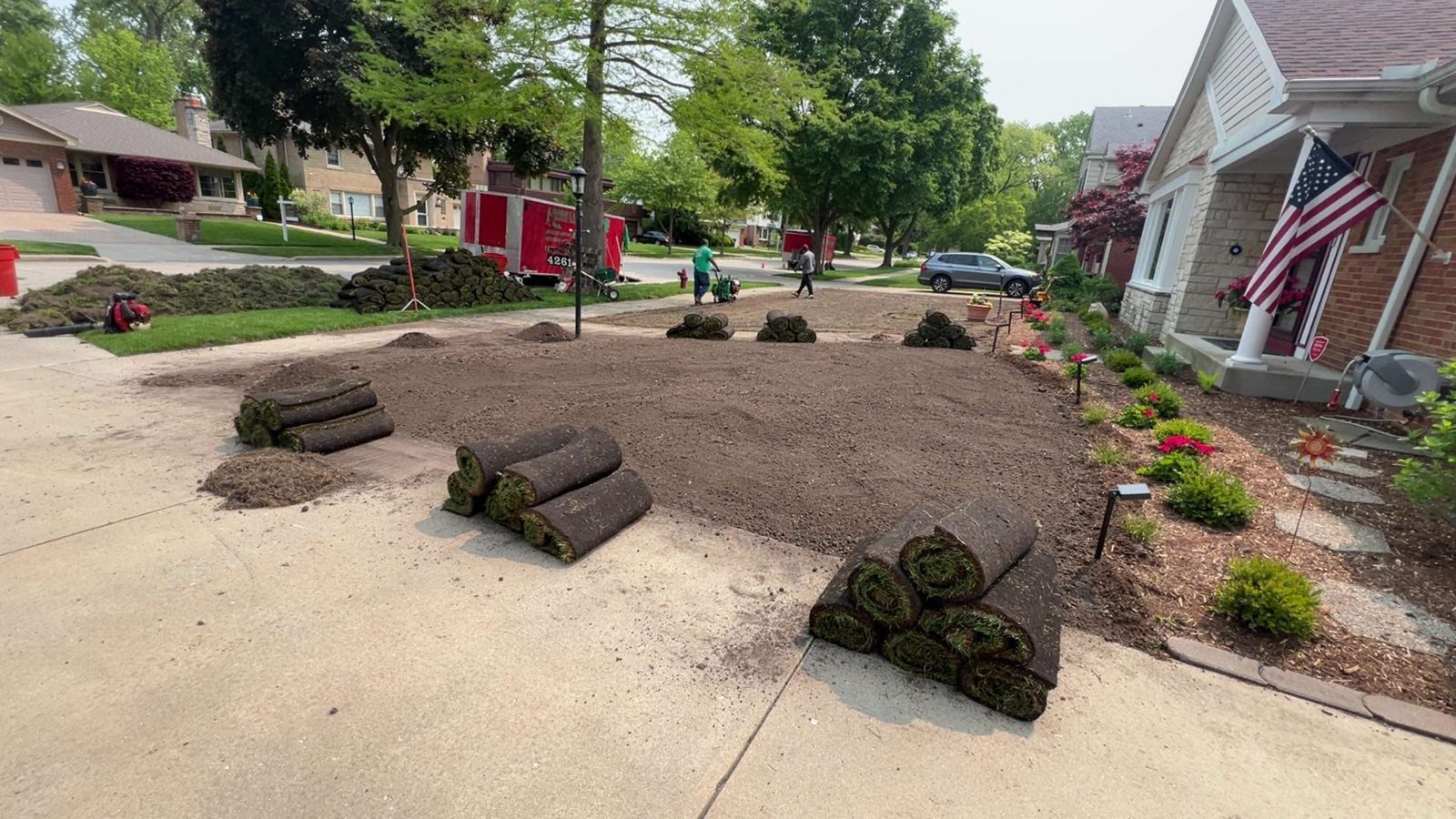 Fresh-cut sod rolls staged on a prepped, graded bed — MarioScape